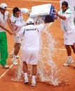 Mexico celebrate their win over Guatemala by drenching their coach 