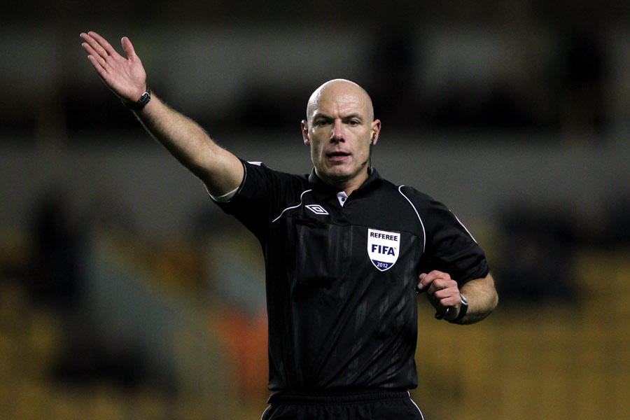 Referee Howard Webb signals to the players