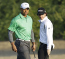 Rory McIlroy walks past partner Tiger Woods