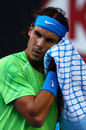Rafael Nadal wipes his face with a towel