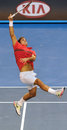 Roger Federer stretches for an overhead shot