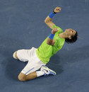 Rafael Nadal sinks to the floor after beating Roger Federer