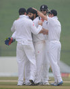 England celebrate Monty Panesar taking the first wicket of the morning