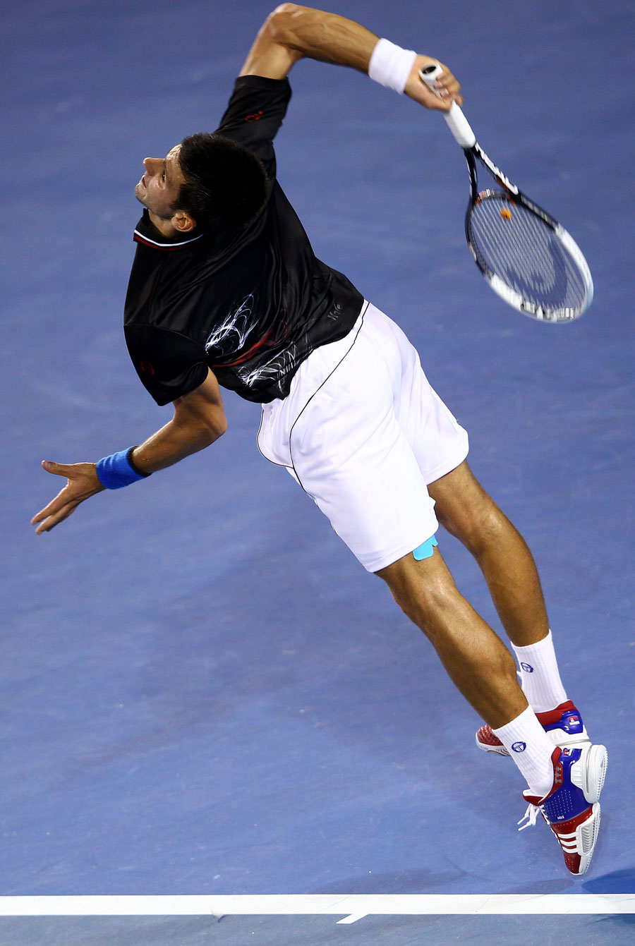 Novak Djokovic puts everything into a serve