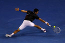 Novak Djokovic stretches to retrieve a backhand