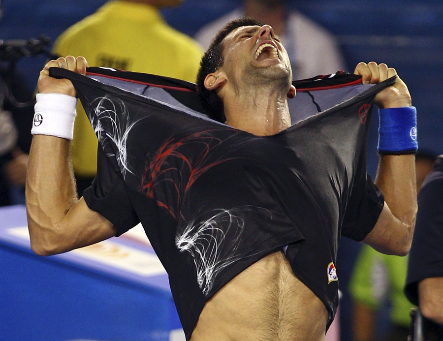 Novak Djokovic rips of his shirt in ecstasy