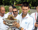 Novak Djokovic celebrates with a furry friend