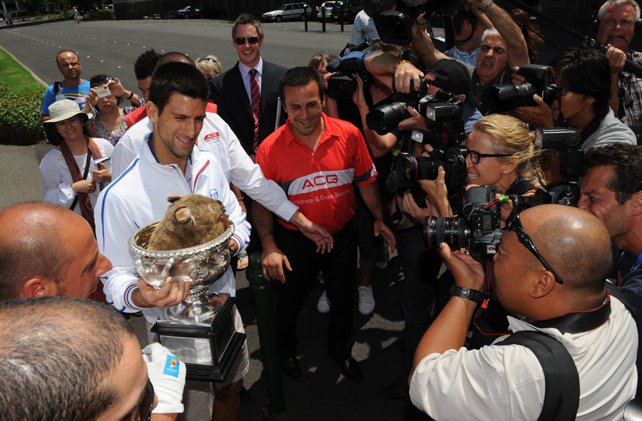 Novak Djokovic is pursued by photographers