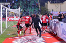 Al-Ahly players run for cover