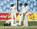 Abdur Rehman kisses the pitch after completing his five-for