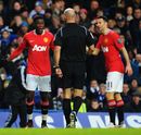 Danny Welbeck and Ryan Giggs appeal to referee Howard Webb