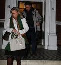 Former England manager Fabio Capello leaves his house alongside his wife