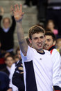 A jubilant Dan Evans waves to the crowd