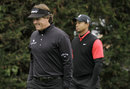 Phil Mickelson and Tiger Woods walk from the second tee