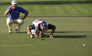 Lee Westwood and his caddie Billy Foster line up a putt
