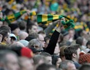 Manchester United fans wave green and yellow scarves