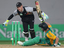 Brendon McCullum reaches for the ball after AB de Villiers falls over attempting a stroke