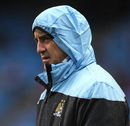 Roberto Mancini shelters from the rain as Man City take on Porto