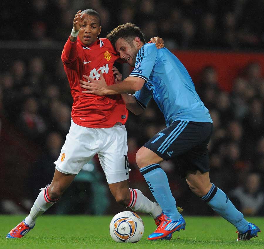 Ashley Young battles for possession