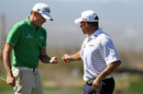 Lee Westwood takes his ball from Nick Watney
