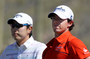 Bae Sang-moon and Rory McIlroy survey the hole