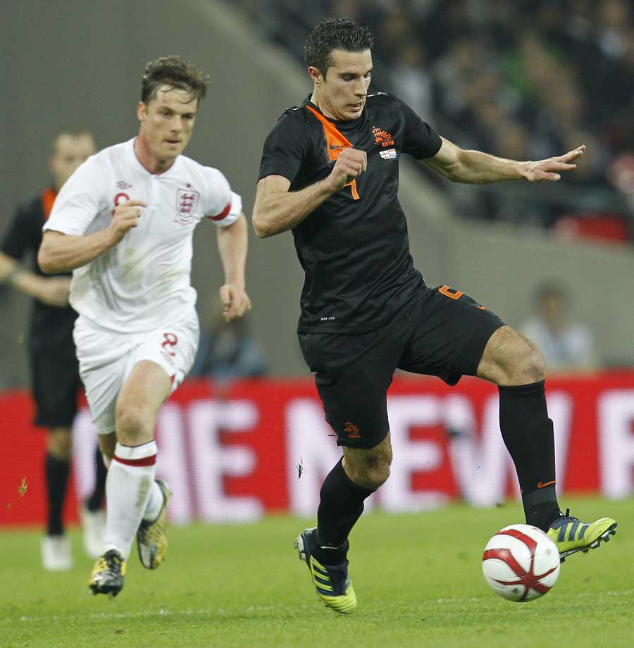 Robin van Persie dribbles with the ball