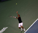 Roger Federer winds up for a serve
