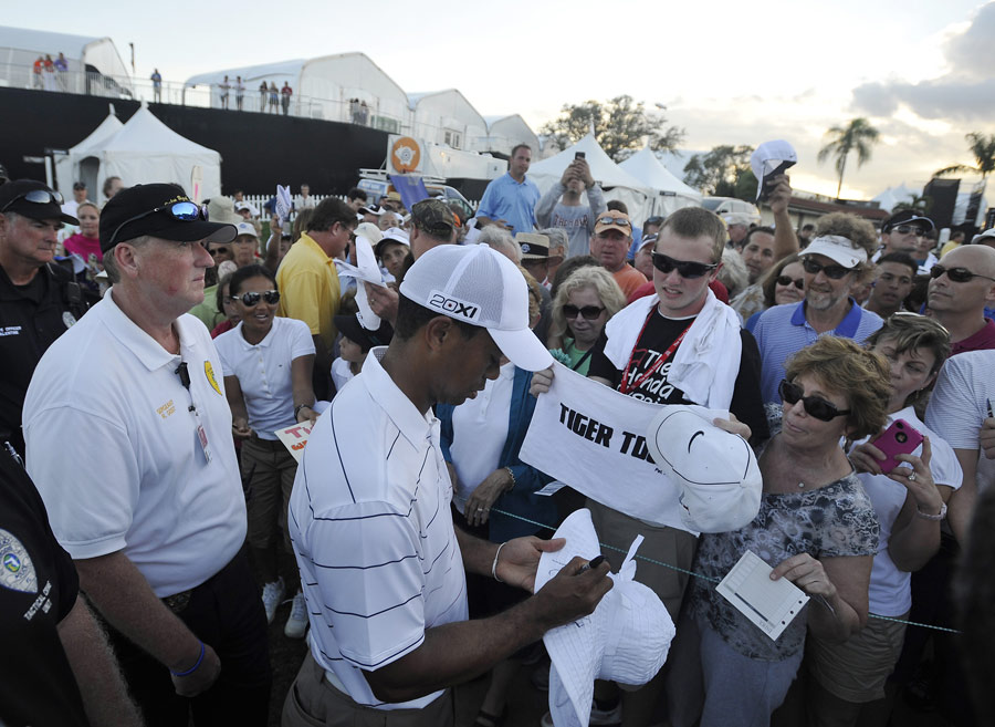Tiger Woods signs autographs