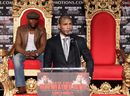Miguel Cotto addresses the media as Floyd Mayweather looks on
