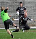 Dirk Kuyt takes a penalty against Pepe Reina during a training session