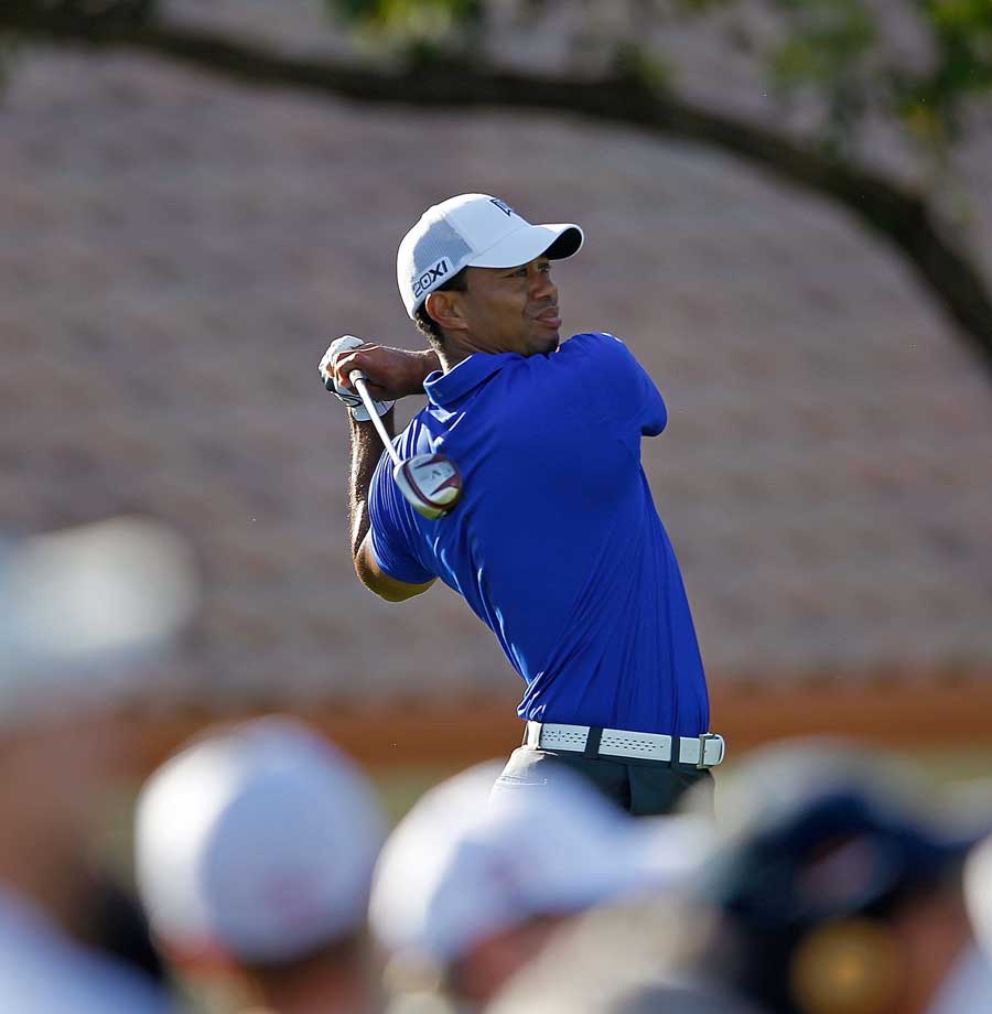 Tiger Woods follows his tee shot