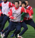 Robin van Persie looks to meet a cross during a training session