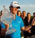 Rory McIlroy poses with the trophy