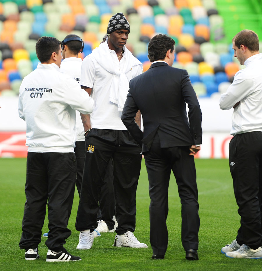 Mario Balotelli stands with his Manchester City team-mates