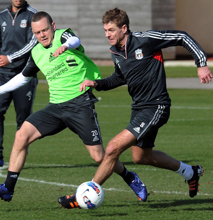Steven Gerrard and Jay Spearing battle for the ball in training