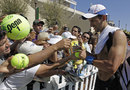 Novak Djokovic signs autographs for fans