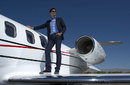 Novak Djokovic stands on the wing of a Bombadier Learjet