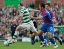 Celtic's Anthony Stokes holds off from Inverness' Roman Golobart