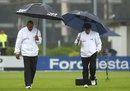 Umpires Aleem Dar and Billy Doctrove inspect the pitch 
