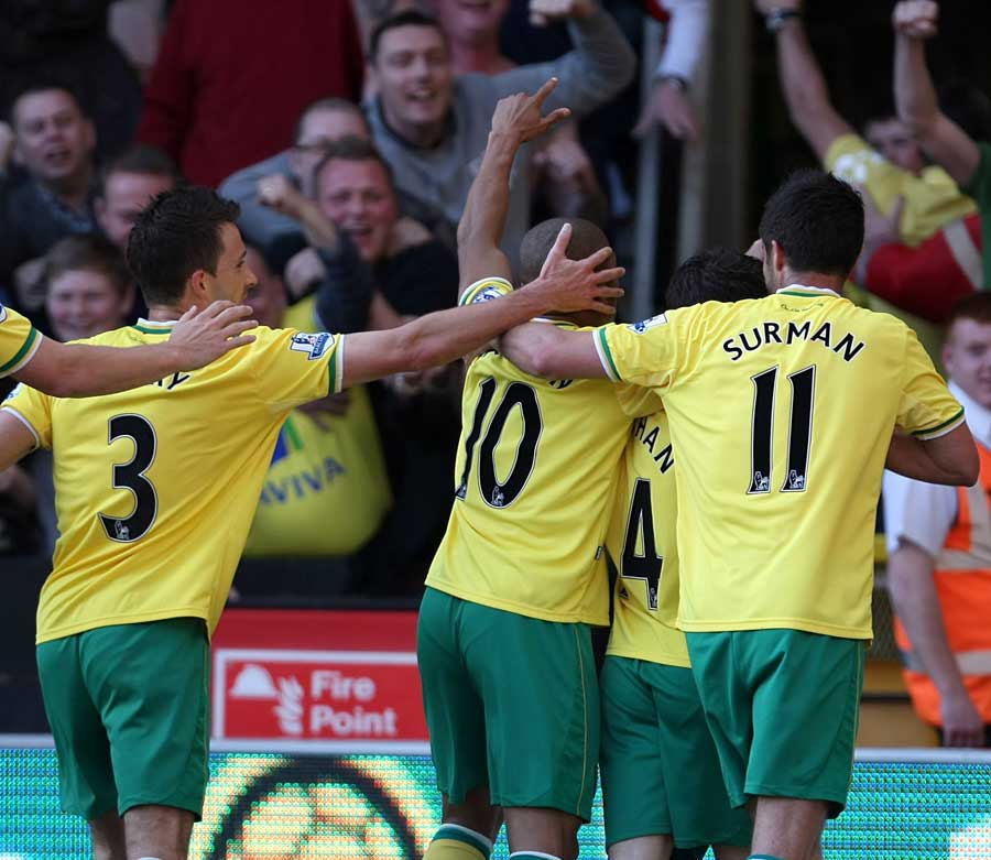 Norwich players celebrate in front of the fans