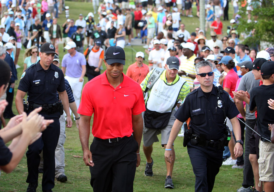 Tiger Woods leaves the golf course after withdrawing from the tournament