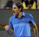 Roger Federer celebrates after winning a game against Milos Raonic