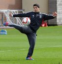 Luis Suarez lines up a volley during a training session