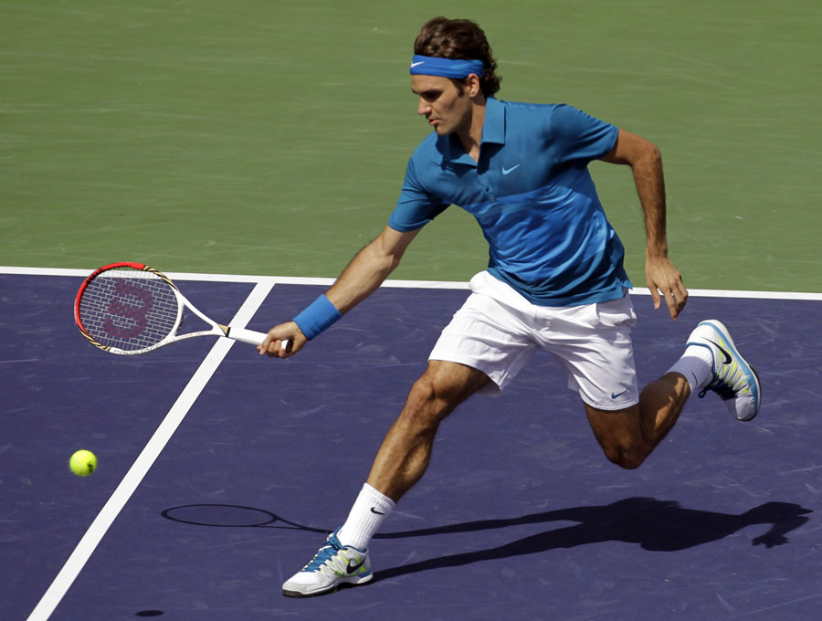 Roger Federer stretches for a return