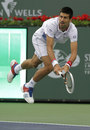 Novak Djokovic leaps to reach a shot