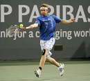 Mardy Fish hits a running forehand