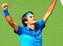Roger Federer celebrates victory over John Isner