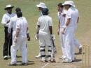 James Anderson argues with Dilruwan Perera as the umpire discusses a decision with England players