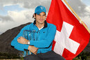 Roger Federer clutches his trophy