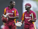Darren Sammy and Kemar Roach walk off after the match is tied